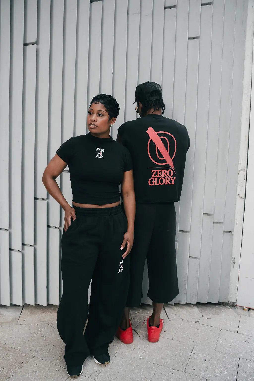 Two models wearing Faith Based Conversation Starter Shirts, stylishly posing against a modern backdrop.
