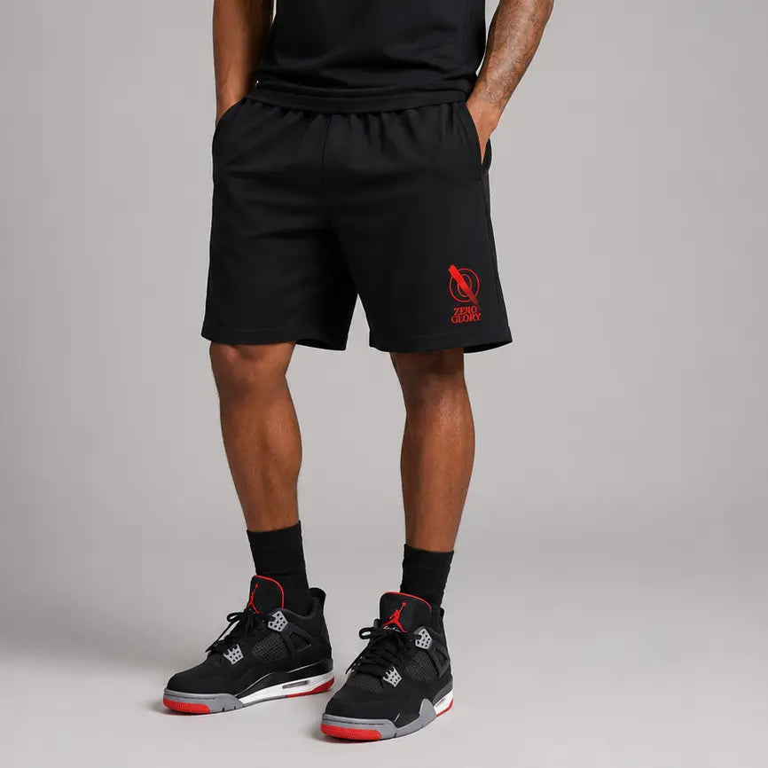 Man wearing Christian performance shorts in black, paired with stylish sneaker shoes.