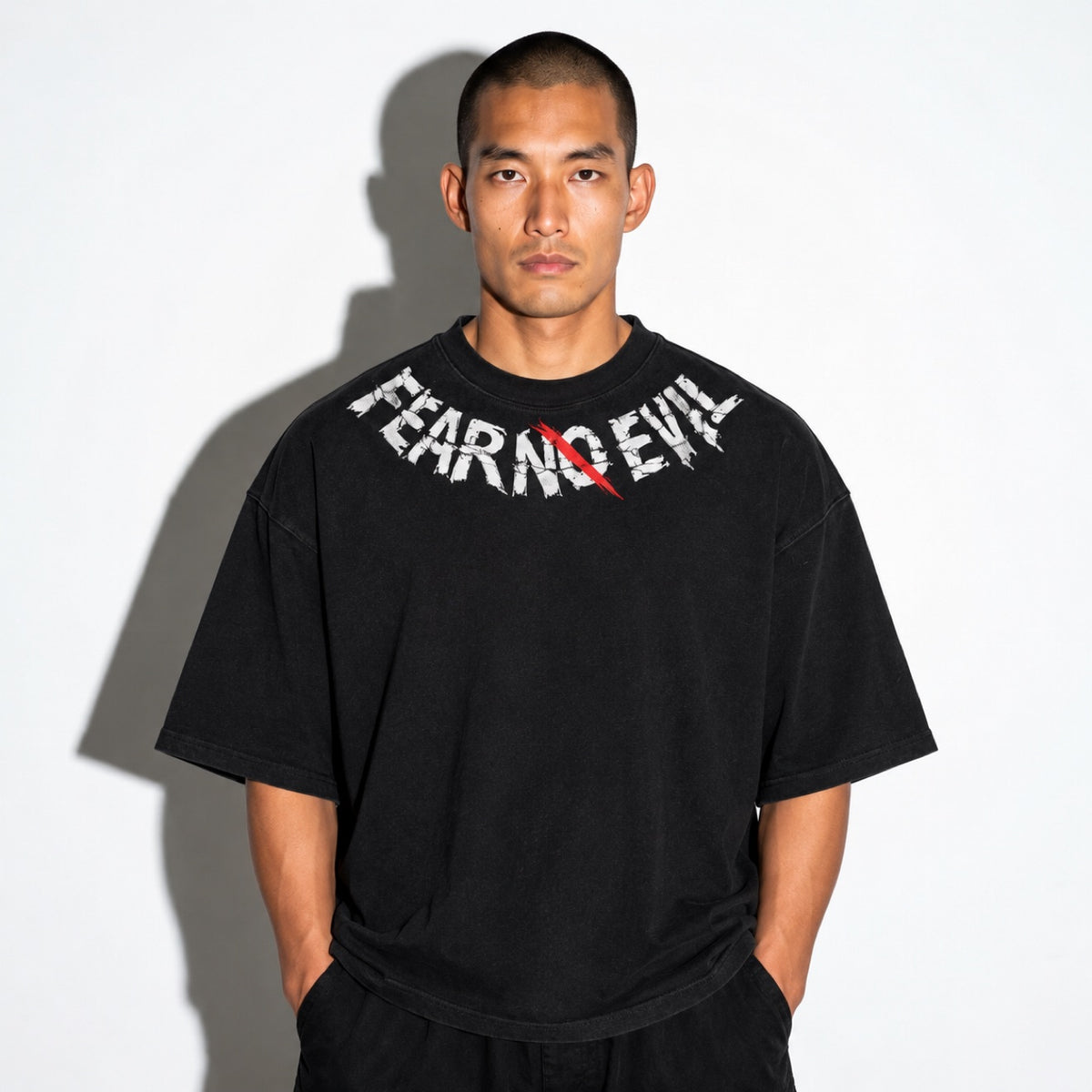 Black boxy tee with distressed arched FEAR NO EVIL front graphic