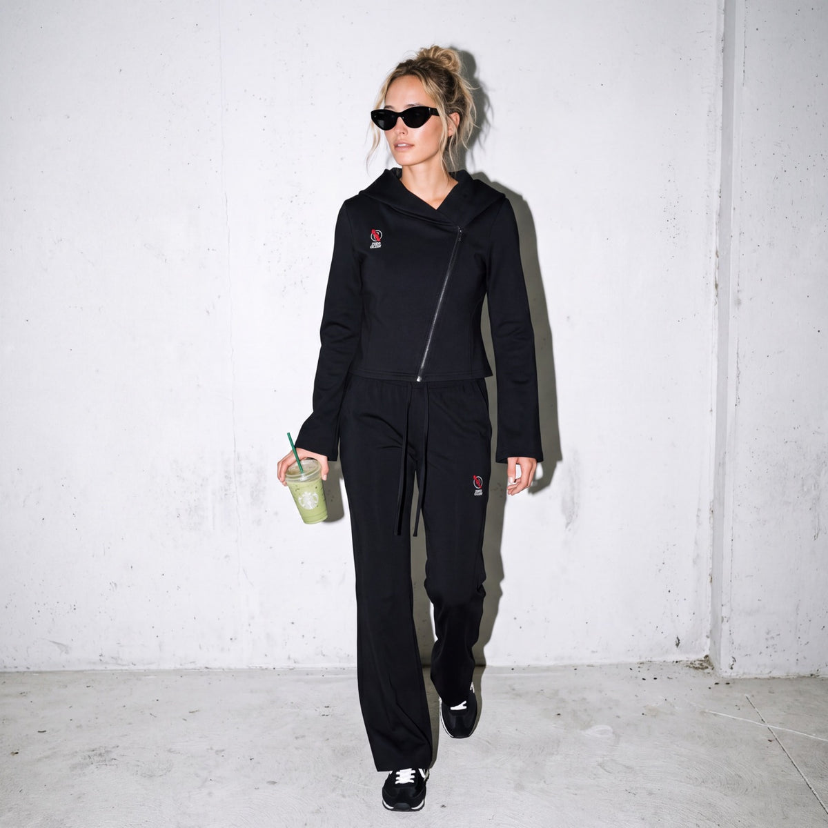 Model wearing the Zero Glory Women's Asymmetric Zip Hoodie and Women's Flared Leg Sweatpants — front view