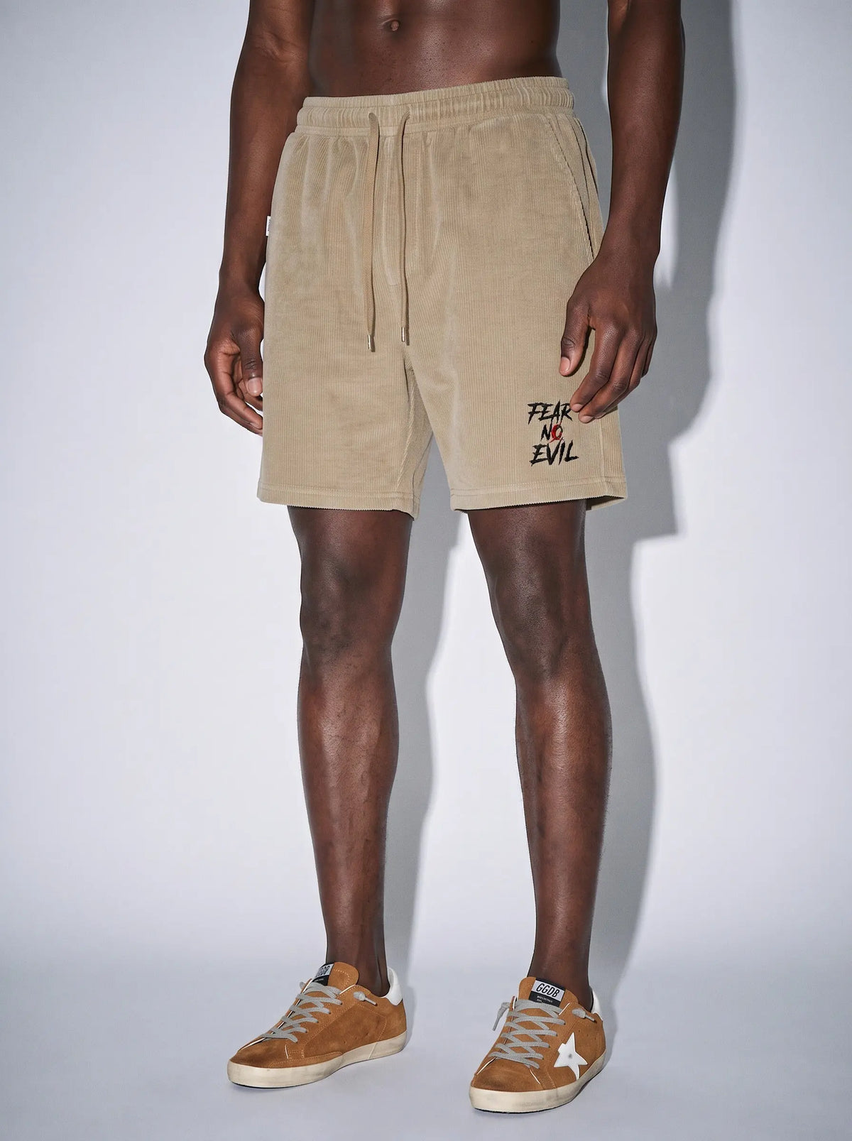 Model wearing Fear No Evil Refined Waffle Shorts, showcasing adjustable drawstring waist and relaxed fit.