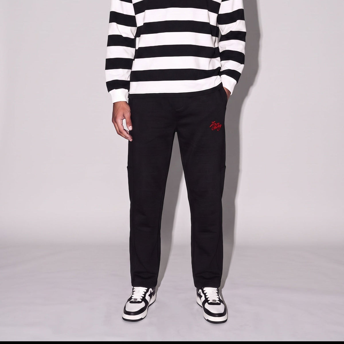 Model wearing Heavyweight Narrow way straight leg pants with black and white striped top and sneakers.