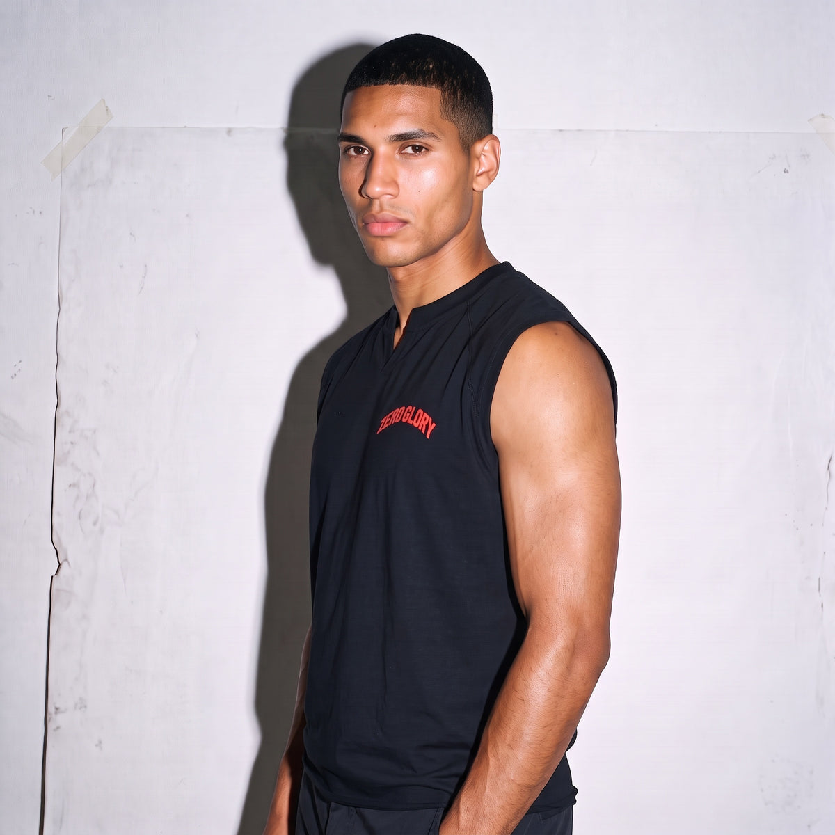 Vintage boxy raw hem tank top by Zero Glory model wearing black sleeveless shirt with ribbed collar