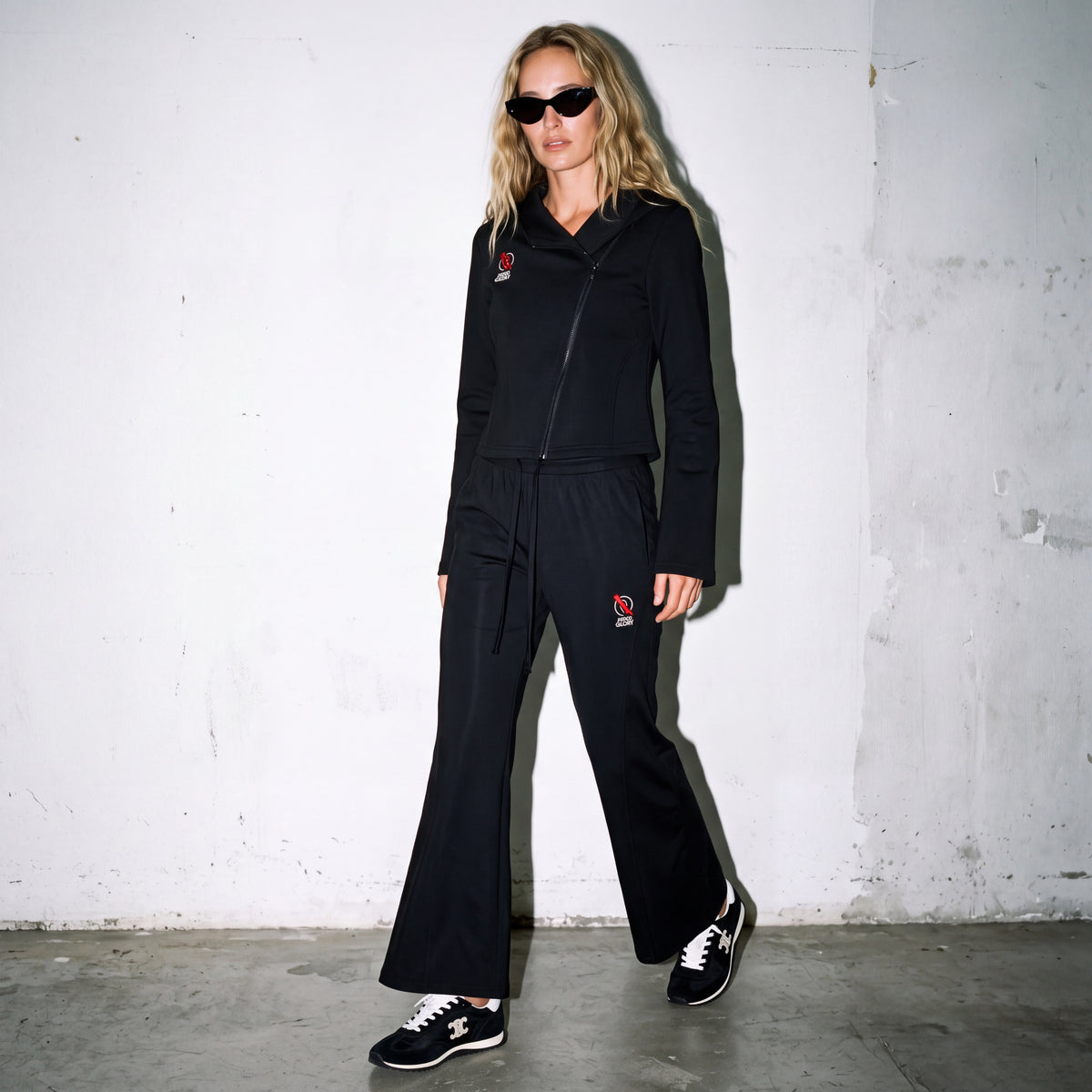 Model wearing Zero Glory Women's Flared Leg Sweatpants with the Asymmetric Zip Hoodie