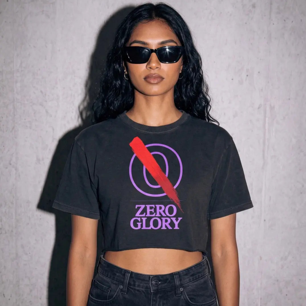 Model wearing a black Purple crop top cotton with a graphic logo, styled with sunglasses against a textured background.