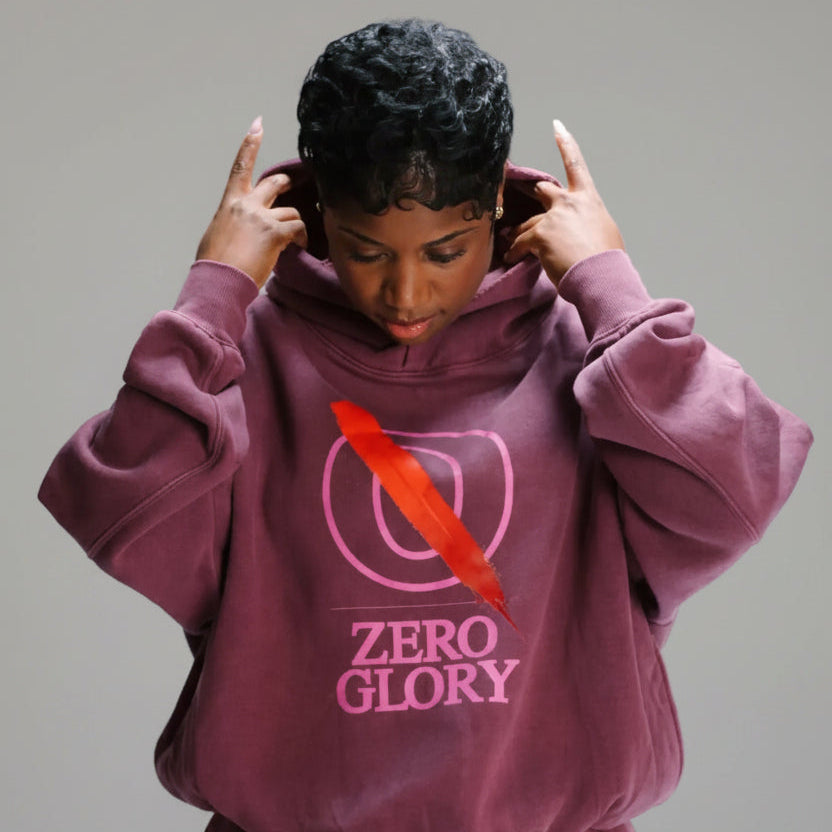 Woman wearing a Pepto Hoodie by Zero Glory in vintage washed finish, showcasing its oversized fit and streetwear style.