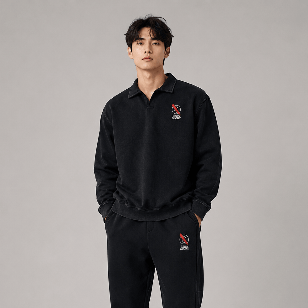 Collared sweatshirt for casual wear worn by a model in black with embroidered details, showcasing relaxed style.