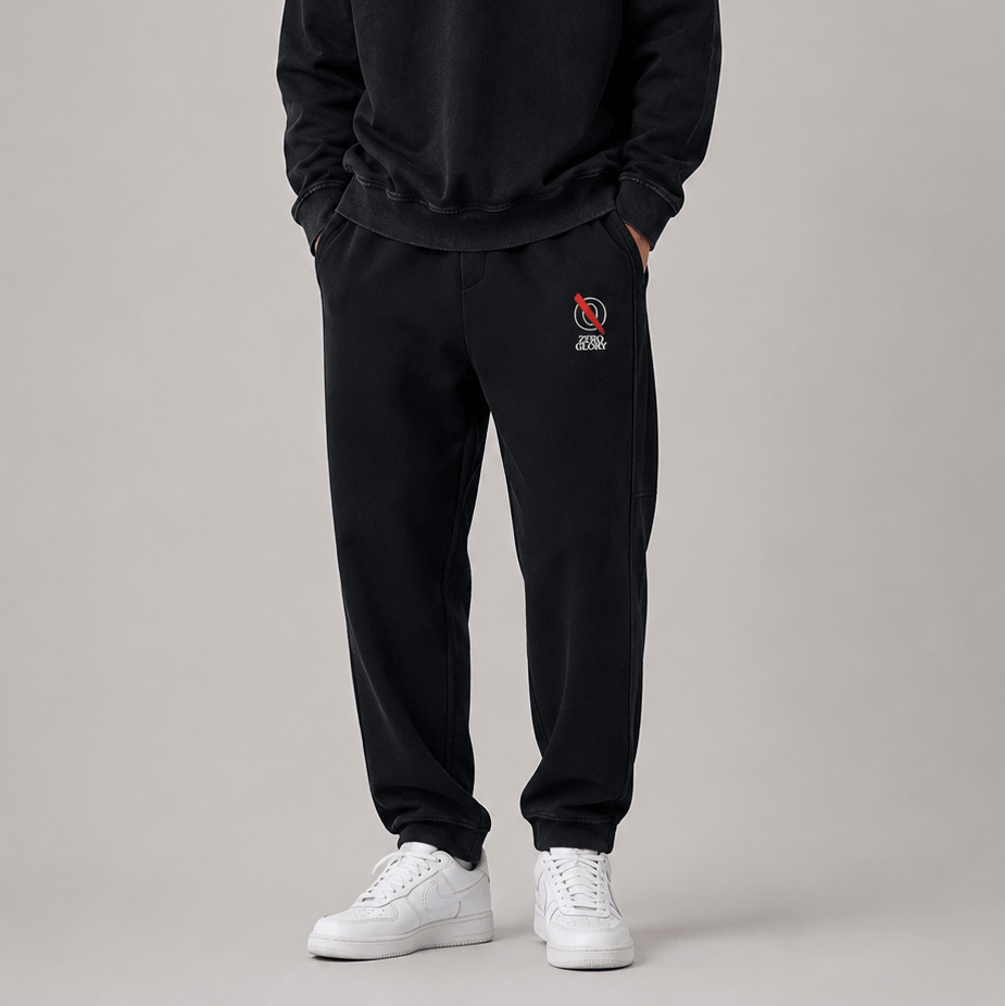 Tapered straight hem sweatpants displayed on a person, featuring a logo and paired with a sweatshirt and sneakers.