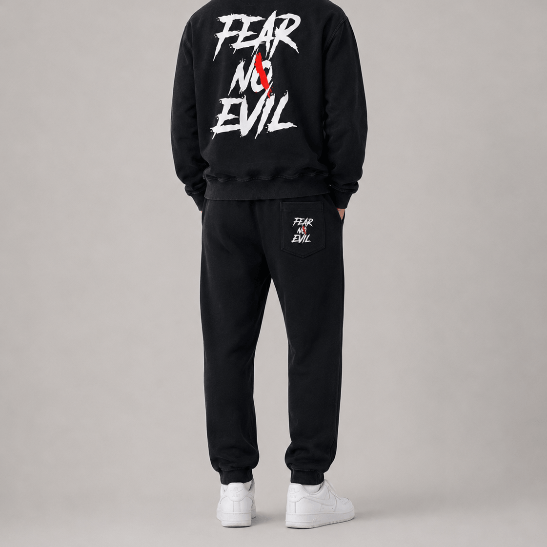 Tapered straight hem sweatpants shown from the back, featuring a bold 'FEAR NO EVIL' graphic on a black hoodie.