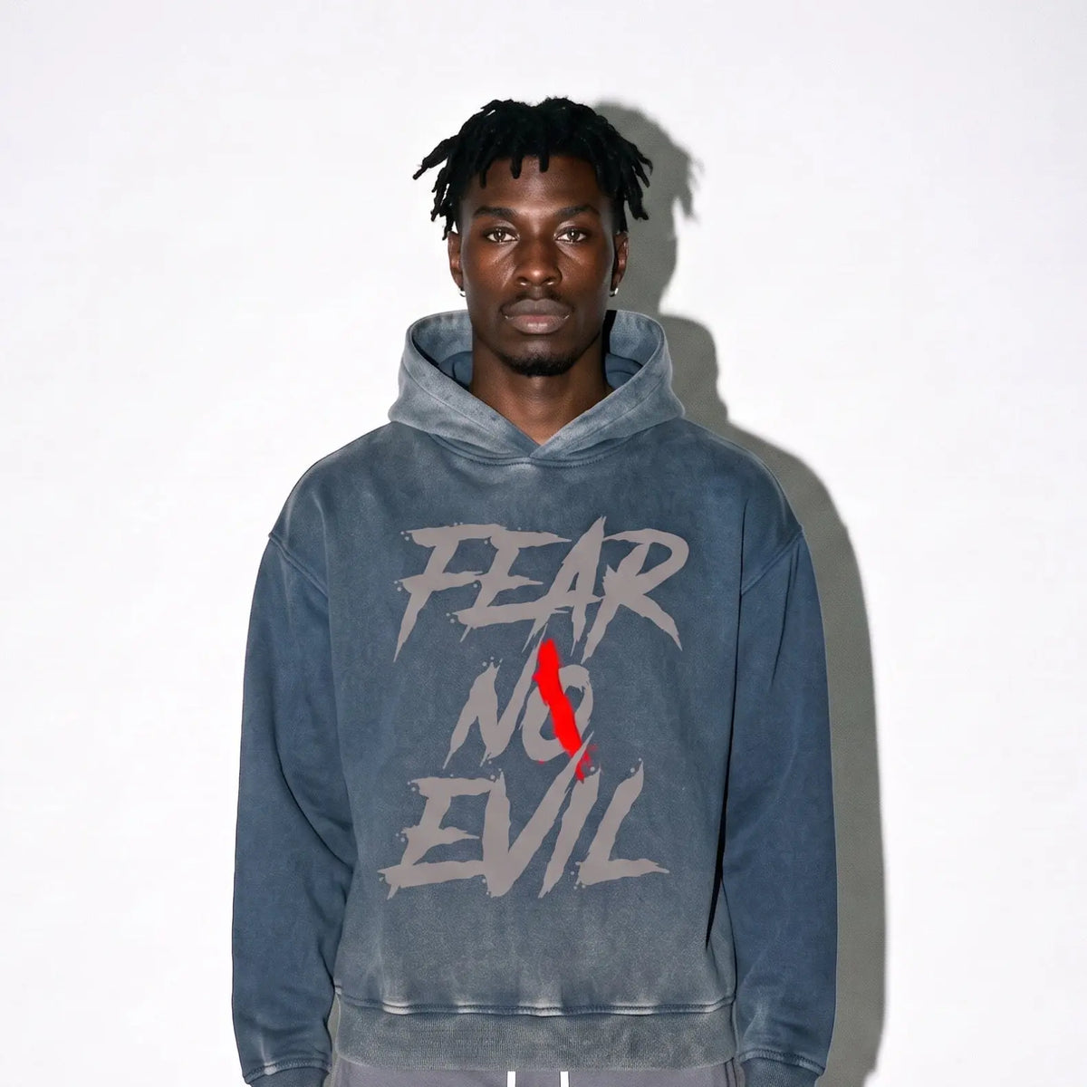 Indigo fleece hoodie featuring a graphic design "FEAR NO EVIL" modeled by a man with long hair against a plain background.