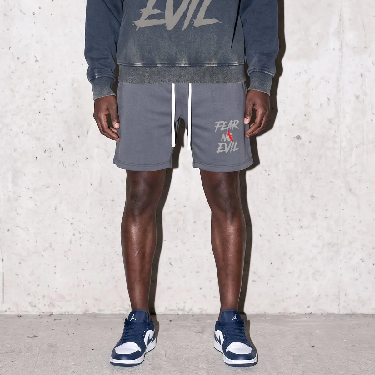 Fear No Evil Indigo Fleece Shorts featured on a model, showcasing bold design and comfortable fit.
